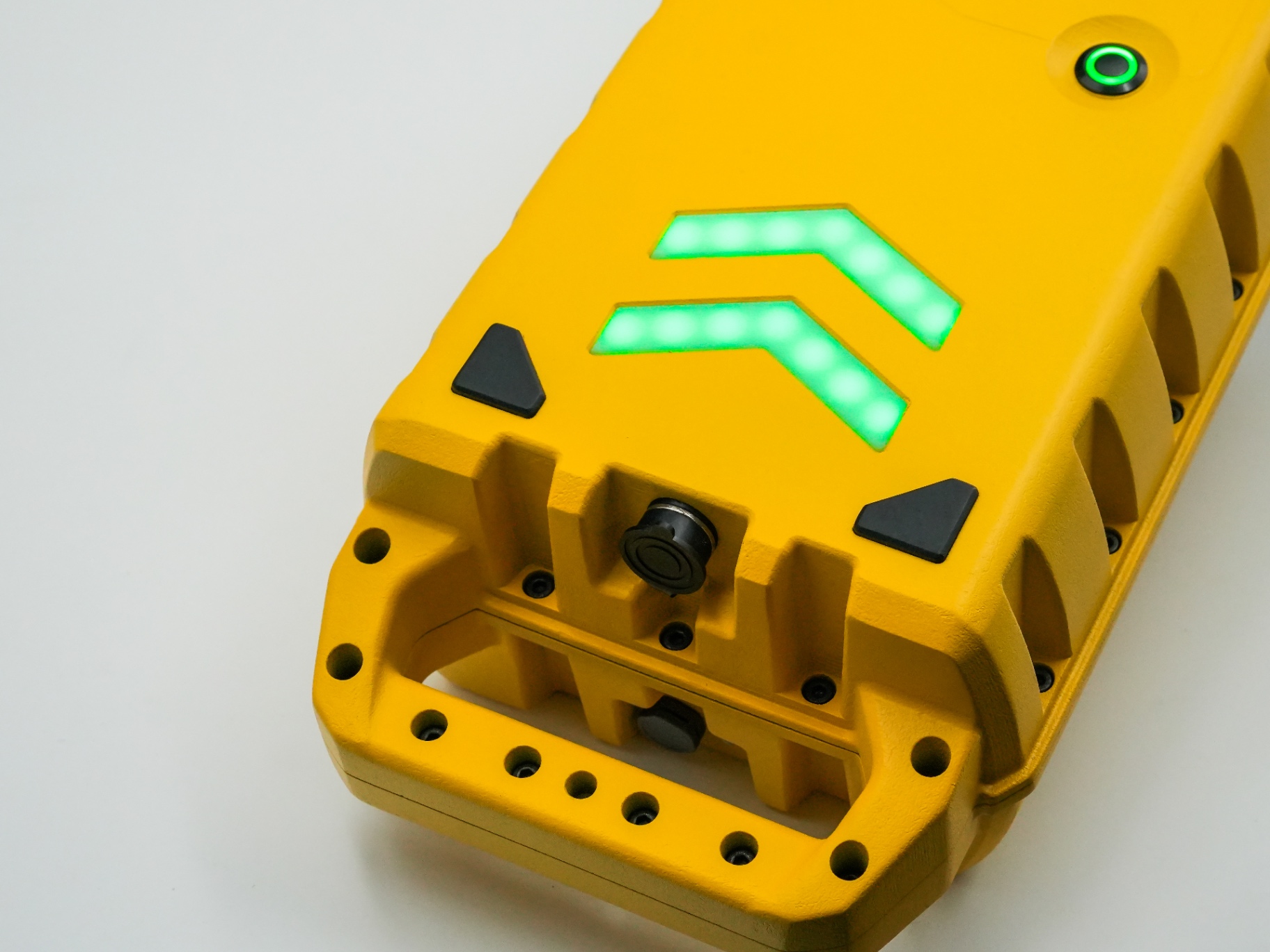 Top detail of the Aero-Jolt GPU showing dual green status chevrons, power indicator and ergonomic grab handle