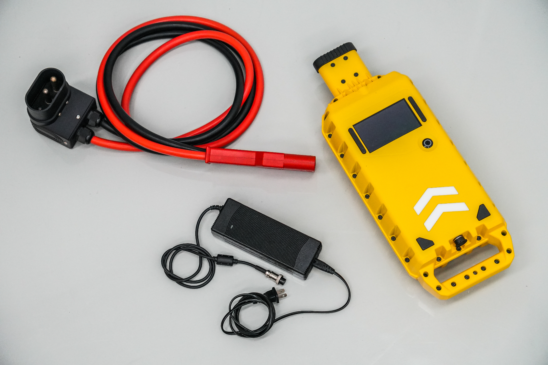 Aero-Jolt 28V portable GPU shown with its universal charger, extension umbilical and 3-pin output cable